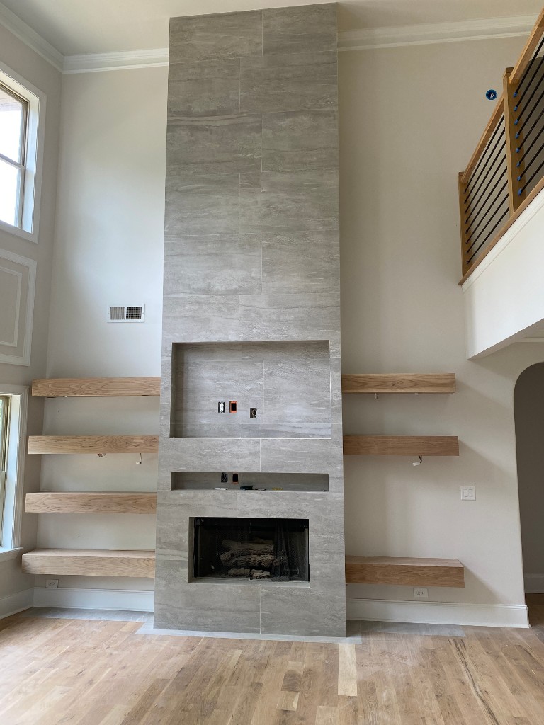 Custom stone fireplace and floating shelves