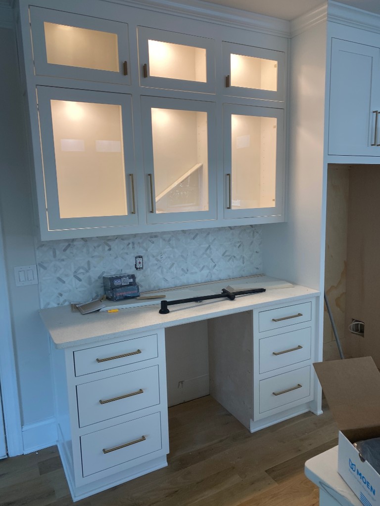 Custom built-in cabinetry with gold hardware
