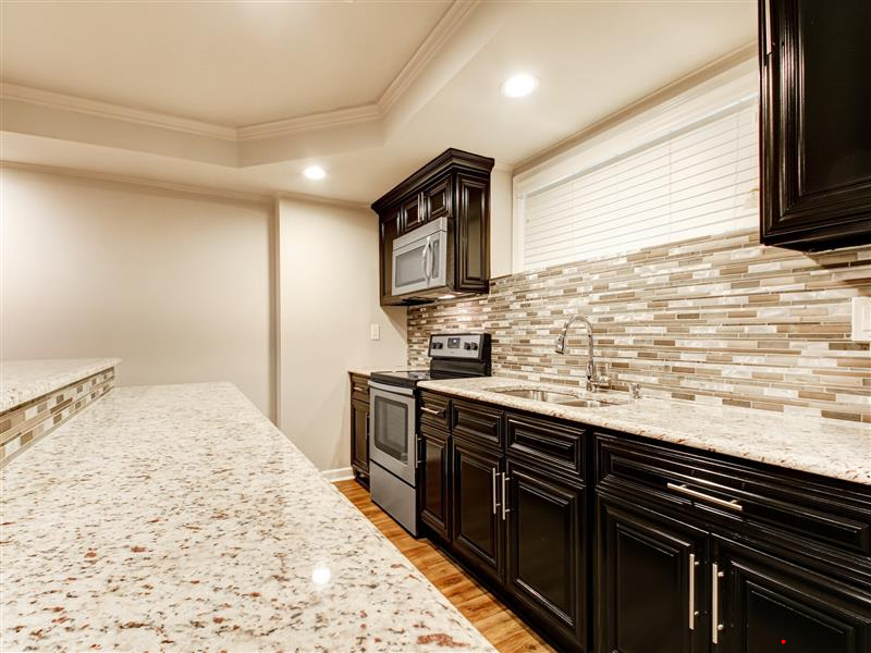 Dark wood kitchen remodel with granite counters