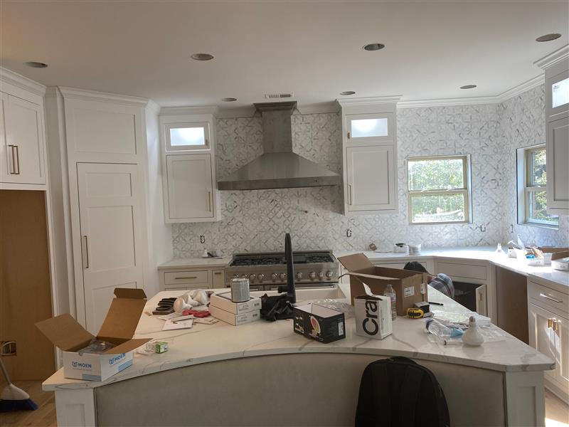 White kitchen renovation with marble counters